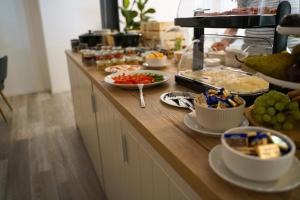 a buffet with food on a wooden counter top at Ley Hotel in Klotten +9 photos