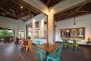 a dining room with wooden tables and chairs at Korurua Dijiwa Ubud in Ubud +28 photos
