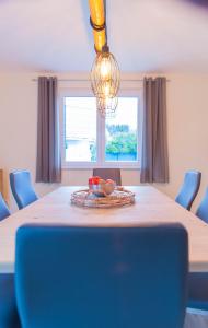 a dining room table with a plate of fruit on it at Haus Mainsee in Sietow Dorf