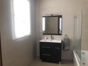 a bathroom with a sink and a mirror and a shower at A Xalda in Vilagarcia de Arousa +15 photos