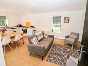 a living room with a couch and a table and chairs at Kealduff Lower in Glenbeigh