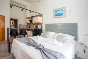 a bedroom with a large bed with white sheets at Apartments Nedo Dalmatia in Omiš