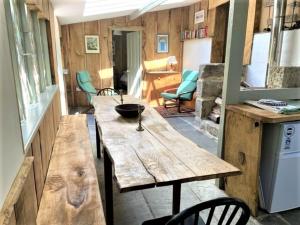 a large wooden table in a tiny house at Wodehouse in Falmouth
