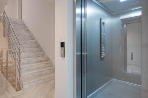 a hallway with a refrigerator and a staircase at Luxury Apartment Solinka With Private Parking in Solin