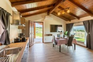 a kitchen and dining room with a table and chairs at Casa Grazia in San Giorgio di Pesaro