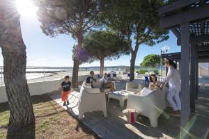 a group of people sitting on a deck near the beach at Belambra Clubs Balaruc-les-Bains - Les Rives De Thau in Balaruc-les-Bains +17 photos