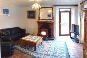 a living room with a couch and a fireplace at The Old Barracks,Caherdaniel in Caherdaniel
