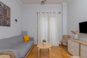 a small living room with a bed and a table at Kerameikos Metro Apartment for 4 in Athens