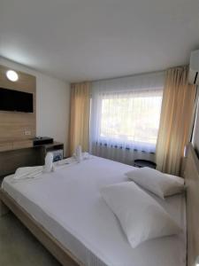 Postel nebo postele na pokoji v ubytování Hotel Gloria