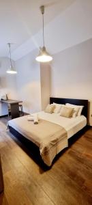 a large bed in a bedroom with two lights at Studio App Aqua in Funtana