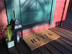 a welcome mat in front of a door at Reinunga Eco Hytta - Mountain lodge near Myrdal accessible only by train or bike in Myrdal