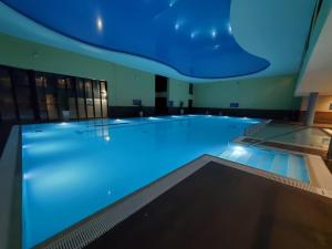 a large swimming pool with blue lighting in a building at Athlone Springs Hotel in Athlone