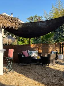a patio with chairs and a table and a hammock at Le Synaya in Sanary-sur-Mer