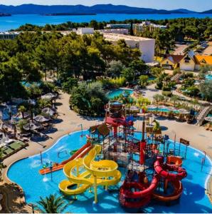 an aerial view of a water park with slides at House vacation with pool,three rooms,near Šibenik in Planjane