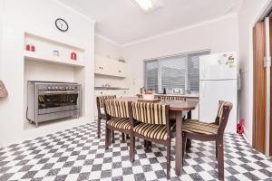 a kitchen with a table and chairs and a refrigerator at River Views in the Heart of Town in Northam