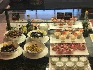 a buffet with many different types of food on plates at Holiday Inn Bursa - City Centre by IHG in Bursa