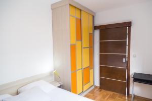 a bedroom with a bed and a colorful closet at Divine in Budva