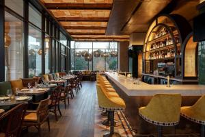 a restaurant with tables and chairs in it at Hyatt Centric Buckhead Atlanta in Atlanta