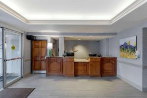 a large room with a kitchen with wooden cabinets at Comfort Inn & Suites Boulder in Boulder