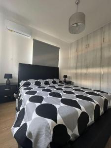 a large black and white bed in a room at Oneiro Napa Suite in Ayia Napa