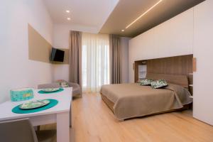 Ένα ή περισσότερα κρεβάτια σε δωμάτιο στο Domina Apartments