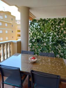a dining table and chairs on a balcony at SUN&BEACH Moncofar in Moncófar