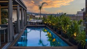 a swimming pool on the roof of a building at Cram Hotel in Barcelona