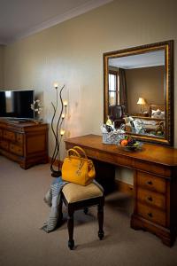 a living room with a chair and a mirror at Great National Hotel Ballina in Ballina