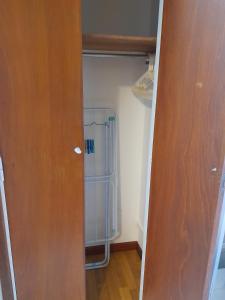 a closet with a refrigerator in a room at Hermoso AMBIENTE con balcón a metros del mar in Mar del Plata