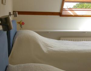 a bed in a room with a window at Rosevallen in Polzeath