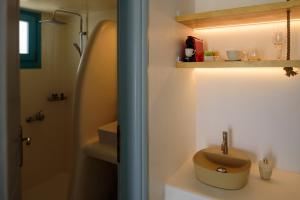 a bathroom with a sink and a shower at Kalestesia Suites in Akrotiri