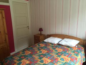 a bedroom with a bed with two pillows on it at appartement à la montagne in Eaux-Bonnes
