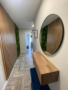 a hallway with a mirror and a wooden table at Apartment Gradus in Dunajská Streda