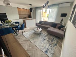 a living room with a couch and a table at Apartment Gradus in Dunajská Streda +11 photos