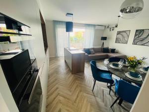 a living room with a couch and a table in a room at Apartment Gradus in Dunajská Streda