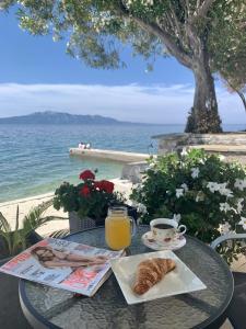 a table with a plate of croissant and a cup of orange juice at Villa Orca in Podaca