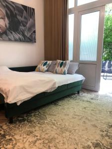 a bedroom with a bed in a room with a window at Garden Apartament Petrila in Petrila