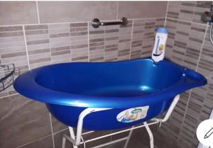 a blue bath tub sitting in a bathroom at Hunyadi utcai garzon in Kaposvár
