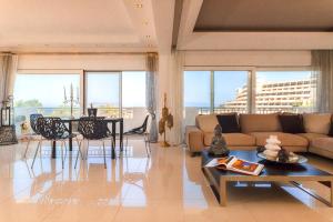 a living room with a couch and a table at Unique Sea & Sunset Residence in Ixia