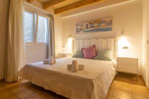 a bedroom with a bed with two towels on it at Can Moreu in Port d’Andratx +31 photos