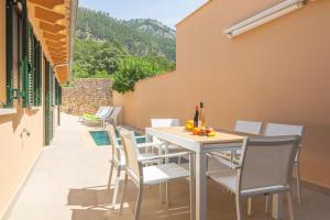 a white table and chairs on a patio at Can Moreu in Port d’Andratx
