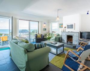 a living room with a couch and a fireplace at Upper Gren in Polzeath