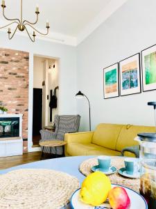 a living room with a yellow couch and a table at Cozy Flat 5 in Constanţa