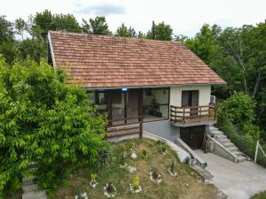 a house with a tile roof and a garden at Weekendaya in Kladovo +25 photos
