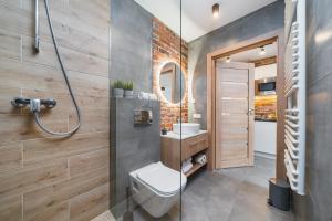 a bathroom with a shower and a toilet and a sink at Saint Florian's Suites - Old Town Luxury Apartments - by Upstairs in Kraków +204 photos
