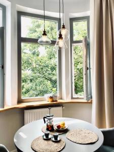 a white table in a room with two windows at Cozy Flat 5 in Constanţa