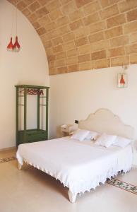 A bed or beds in a room at Masseria Galatea Agriturismo