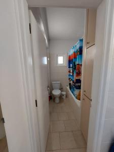 a small bathroom with a toilet and a hallway at Downtown Agia Napa in Ayia Napa