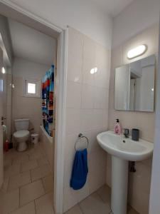 a bathroom with a sink and a toilet at Downtown Agia Napa in Ayia Napa