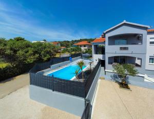 an aerial view of a house with a swimming pool at Modern apartment with private pool in Bibinje